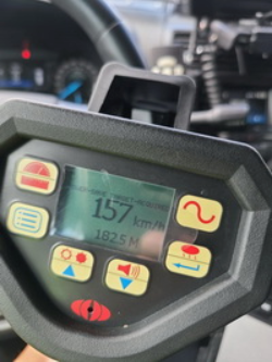 image of speed gun showing 157 km/hr