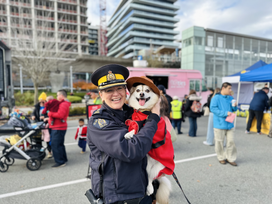 La surintendante Julie Drotar se fait prendre en photo avec un chien vêtu d’un costume de gendarme