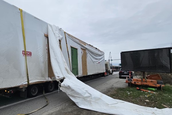Un camion semi-remorque dont le chargement a été endommagé après avoir percuté un pont d’étagement sur la route 99