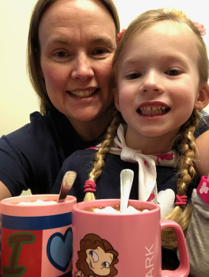 Corporal Wiita and her daughter pose with hot chocolate they made together