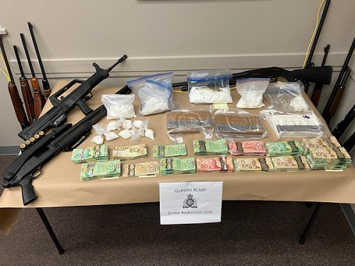 Several bundles of cash including 20, 50 and 100 dollar bills. Several packages of drugs. Several rifles.