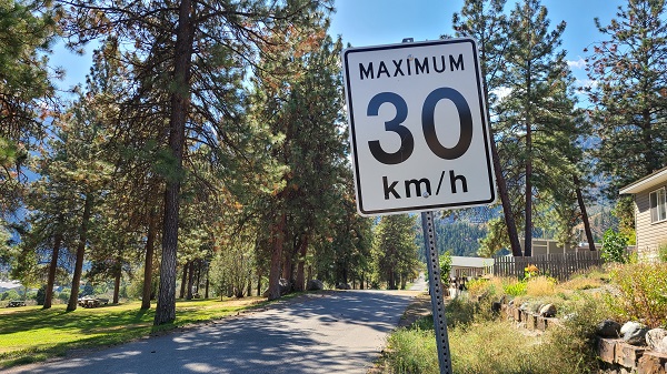 30km/h speed limit sign with view of Hangman Lane and park in the background