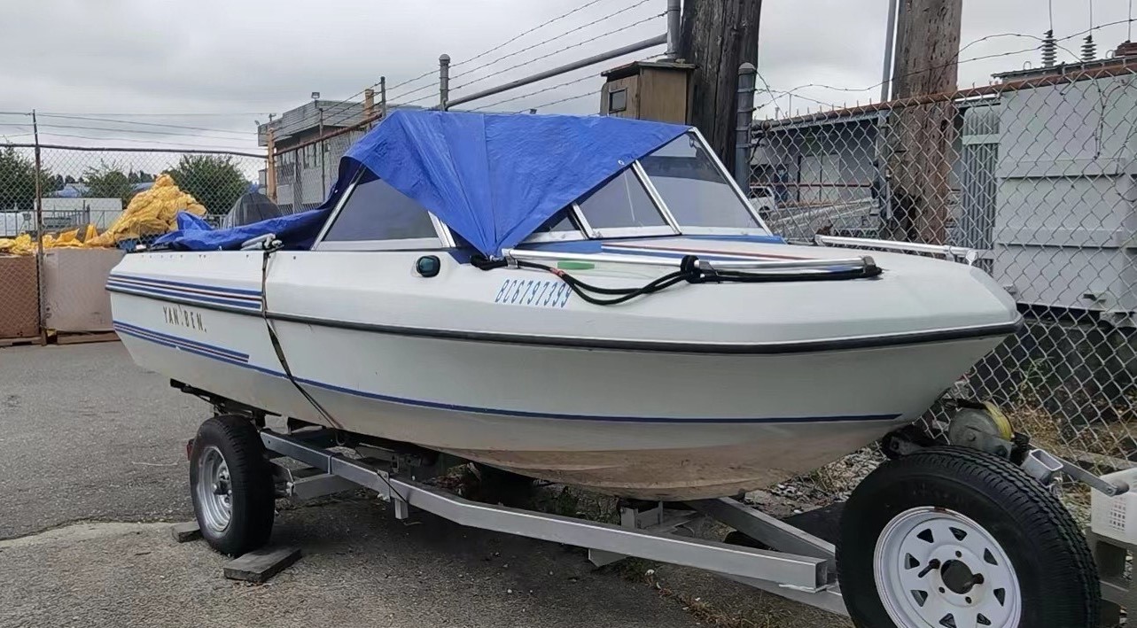 20 foot white boat with blue stripes