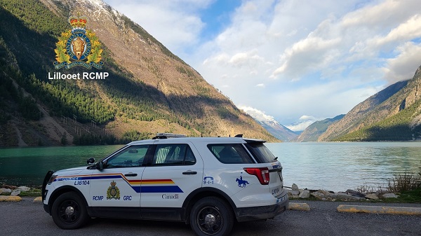 RCMP vehicle with view of Seton Lake and mountain in background