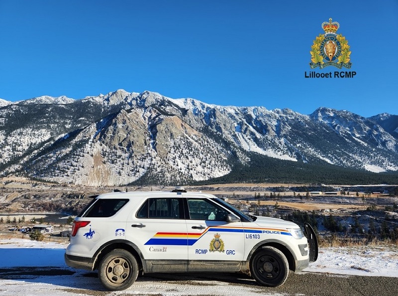 View of RCMP vehicle and mountain range in background