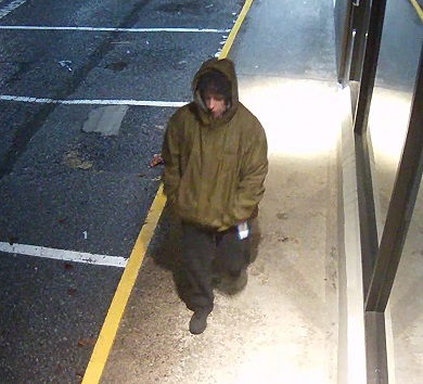 Photo of man wearing green snowbaord style jacket. The man is a suspect in a theft.