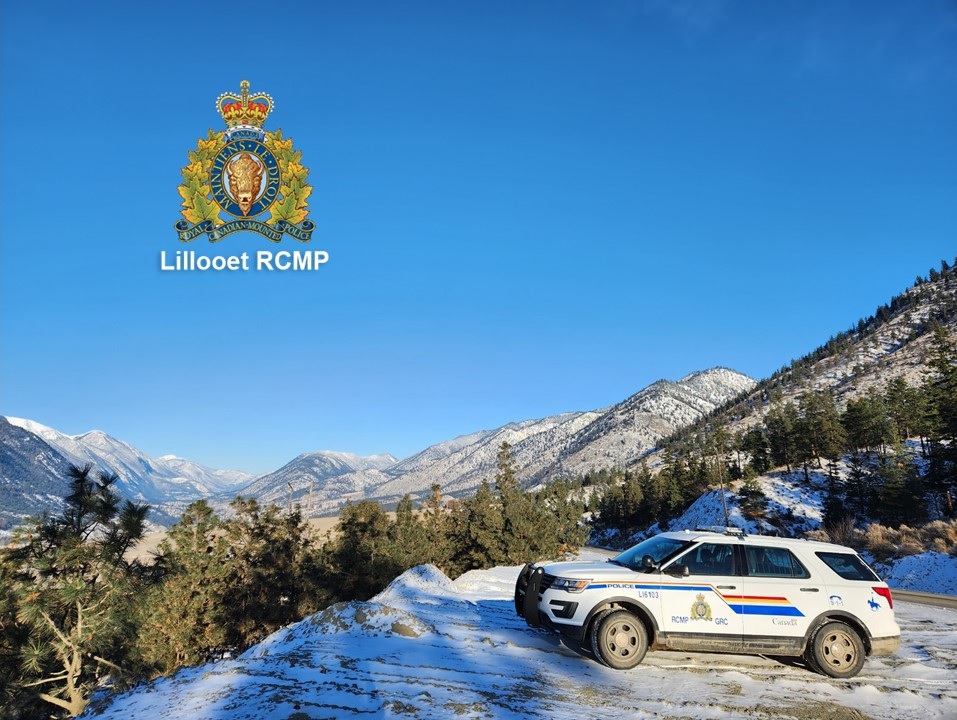 View of police vehicle with view of snowy mountains in background