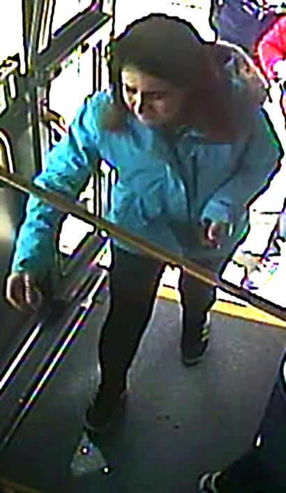 Female in blue jacket entering the bus