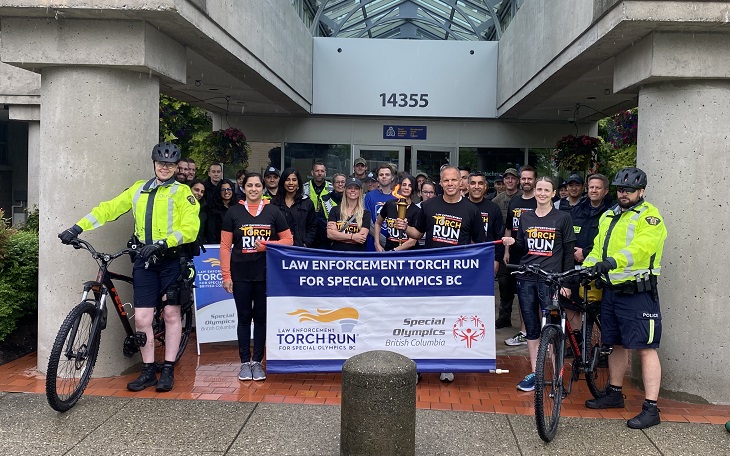 Photo of people gathered at the front of the Surrey RCMP Detachment for the 2022 Law Enforcement Torch Run