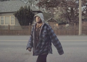 Suspect wearing plaid jacket, with the hood up 