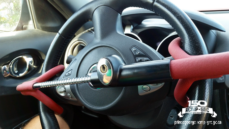 Photo of a steering wheel lock on a steering wheel.