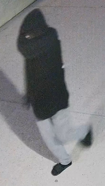 slender male youth suspect with dark hoodie, grey pants, dark slide sandals and socks 