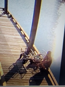 Photo of man sitting on dock