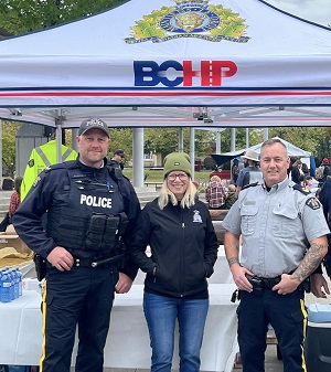Sgt McLaughlin, Cpl Nicolai and Sharon Vanderveld standing in front of the BCHP tent.