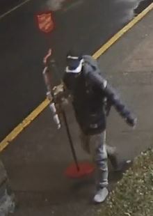 Surveillance still image of suspect carrying the donation kettle