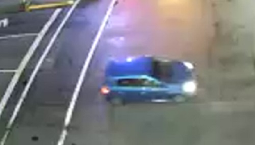 Surveillance camera image of blue car