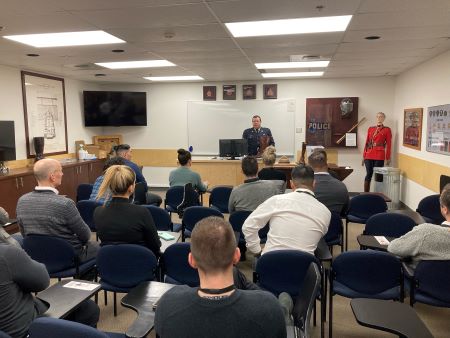 Group of several police seated in a classroom.