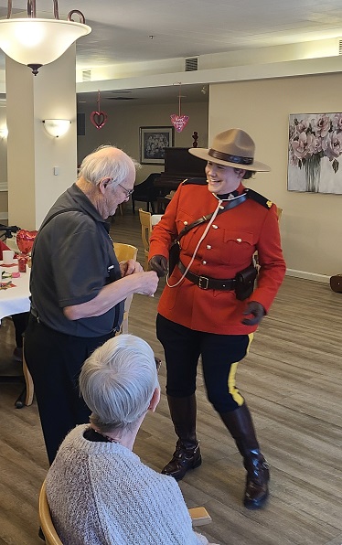 Mr. Gene Morrison and Cst. Justina Webb dancing with woman watching