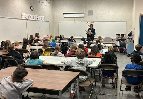 Photo of officer reading to students