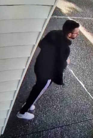 Photo of Jasdeep Parmar standing wearing black jacket and black pants with white stripes down the sides
